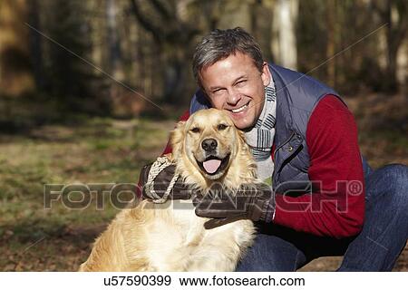 Man Taking Dog On Walk Through Autumn Woods View Large Photo Image Stock Photo - Man Taking Dog On Walk Through Autumn Woods. Fotosearch