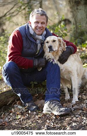 Man Taking Dog On Walk Through Autumn Woods View Large Photo Image Stock Photography - Man Taking Dog On Walk Through Autumn Woods. Fotosearch
