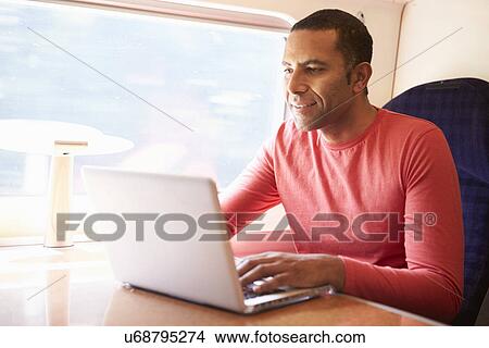 Man Using Laptop On Train View Large Photo Image Picture - Man Using Laptop On Train. Fotosearch