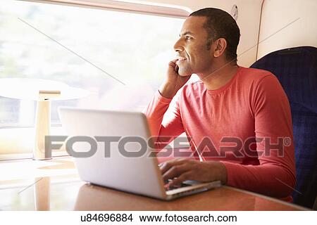 Man Using Laptop On Train View Large Photo Image Picture - Man Using Laptop On Train. Fotosearch