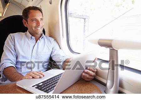 Man Using Laptop On Train View Large Photo Image Picture - Man Using Laptop On Train. Fotosearch