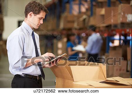 Manager In Warehouse Checking Boxes Using Digital Tablet View Large Photo Image Stock Image - Manager In Warehouse Checking Boxes Using Digital Tablet. Fotosearch