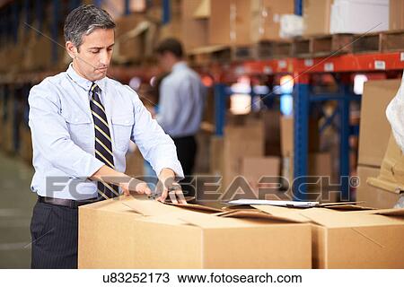 Manager In Warehouse Checking Boxes View Large Photo Image Stock Image - Manager In Warehouse Checking Boxes. Fotosearch