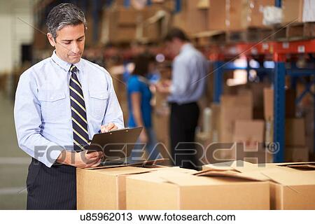 Manager In Warehouse Checking Boxes View Large Photo Image Stock Image - Manager In Warehouse Checking Boxes. Fotosearch