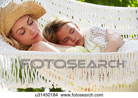 Picture - Mother And Daughter Relaxing In Beach Hammock. Fotosearch
