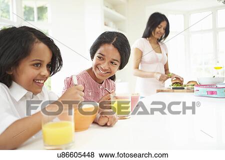 Mother Making School Packed Lunches For Children View Large Photo Image Stock Photo - Mother Making School Packed Lunches For Children. Fotosearch