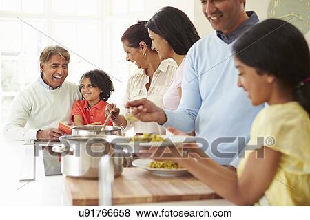 Multi Generation Indian Family Cooking Meal At Home View Large Photo Image Stock Photo - Multi Generation Indian Family Cooking Meal At Home. Fotosearch