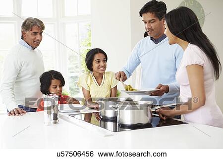 Stock Photograph - Multi Generation Indian Family Cooking Meal At Home. Fotosearch