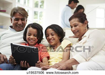 Stock Photograph - Multi-Generation Indian Family With Digital Tablet. Fotosearch