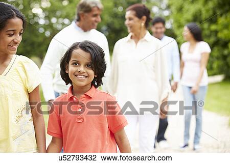 Stock Image - Muti-Generation Indian Family Walking In Countryside. Fotosearch