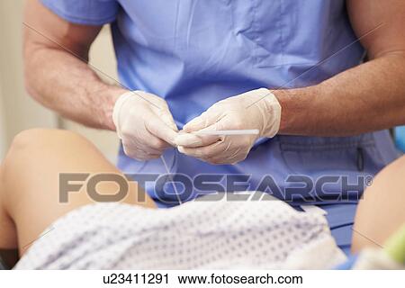Stock Image - Nurse In Operating Theatre Wearing Scrubs And Mask. Fotosearch