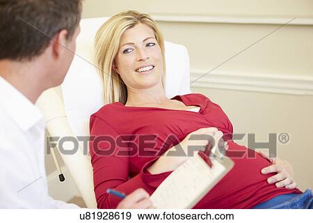 Stock Photo - Nurse Using Digital Tablet In Meeting With Pregnant Woman. Fotosearch