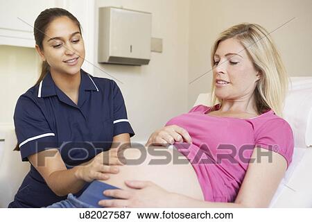 Nurse Using Digital Tablet In Meeting With Pregnant Woman View Large Photo Image Stock Photo - Nurse Using Digital Tablet In Meeting With Pregnant Woman. Fotosearch