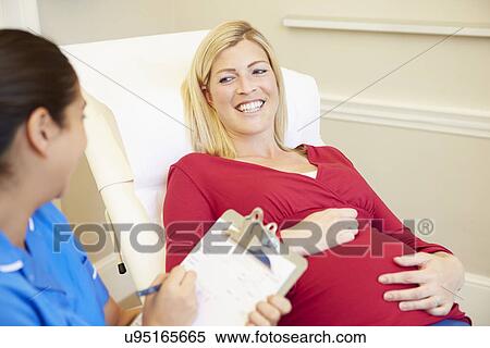 Nurse Using Digital Tablet In Meeting With Pregnant Woman View Large Photo Image Stock Photography - Nurse Using Digital Tablet In Meeting With Pregnant Woman. Fotosearch