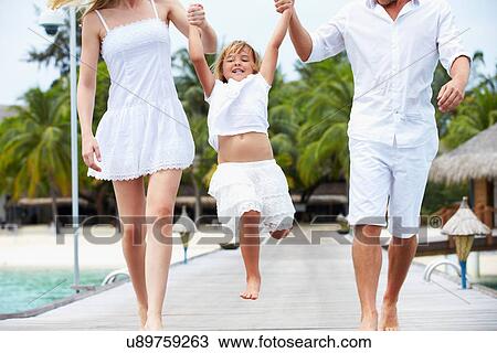 Parents Swinging Daughter As They Walk Along Wooden Jetty View Large Photo Image Stock Image - Parents Swinging Daughter As They Walk Along Wooden Jetty. Fotosearch