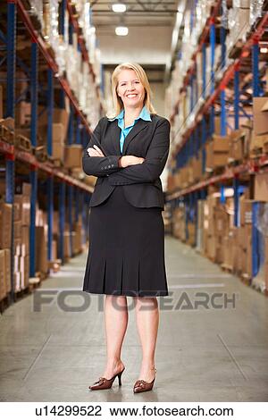 Stock Image - Portrait Of Female Manager In Warehouse. Fotosearch