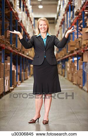 Stock Photography - Portrait Of Female Manager In Warehouse. Fotosearch