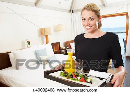 Stock Photo - Portrait Of Hotel Worker Delivering Room Service Meal. Fotosearch