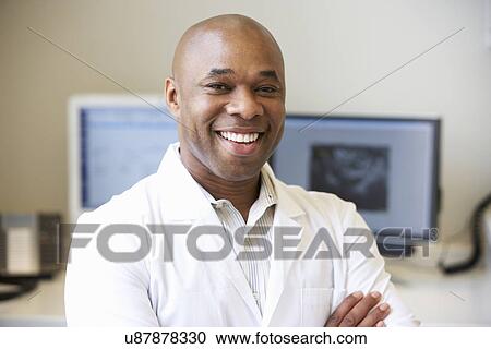 Stock Image - Portrait Of Male Obstetrician In Hospital. Fotosearch