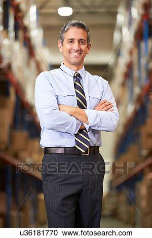 Stock Image - Portrait Of Manager In Warehouse. Fotosearch