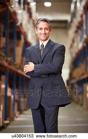 Stock Image - Portrait Of Manager In Warehouse. Fotosearch