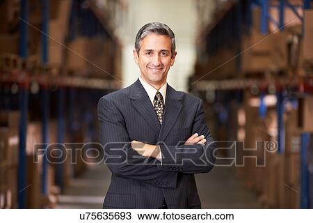 Stock Image - Portrait Of Manager In Warehouse. Fotosearch