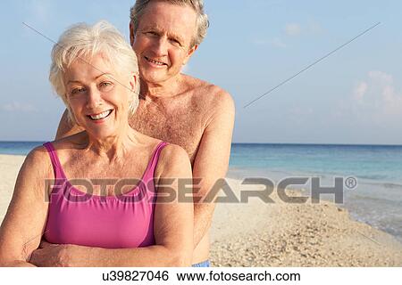 Stock Photograph - Portrait Of Senior Couple On Tropical Beach Holiday. Fotosearch