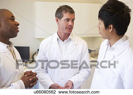 Stock Image - Portrait Of Three Doctors In American Hospital. Fotosearch