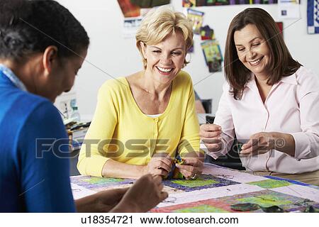 Stock Image - Portrait Of Woman Sewing Quilt. Fotosearch