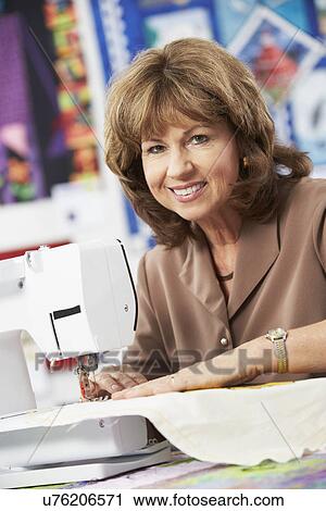 Portrait Of Woman Using Electric Sewing Machine View Large Photo Image Stock Image - Portrait Of Woman Using Electric Sewing Machine. Fotosearch