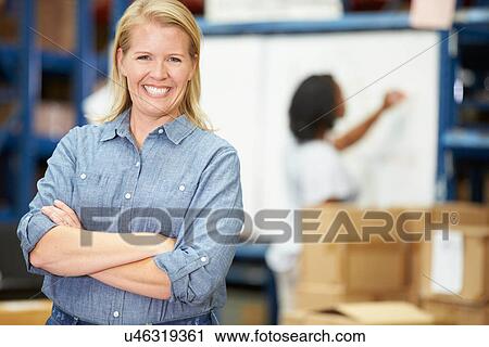 Stock Image - Portrait Of Worker In Distribution Warehouse. Fotosearch