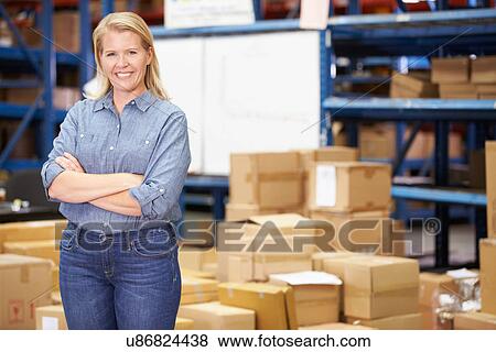 Stock Photo - Portrait Of Worker In Distribution Warehouse. Fotosearch