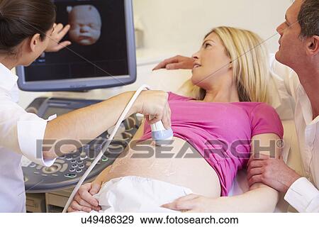 Stock Photo - Pregnant Woman And Having 4D Ultrasound Scan. Fotosearch