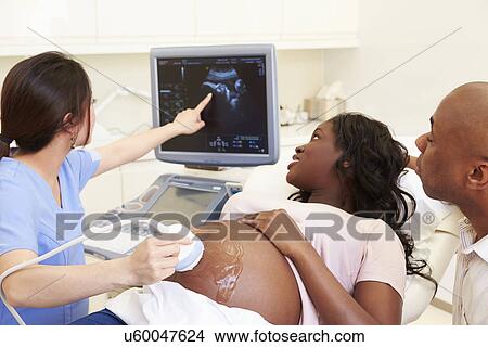 Picture - Pregnant Woman And Partner Having 4D Ultrasound Scan. Fotosearch