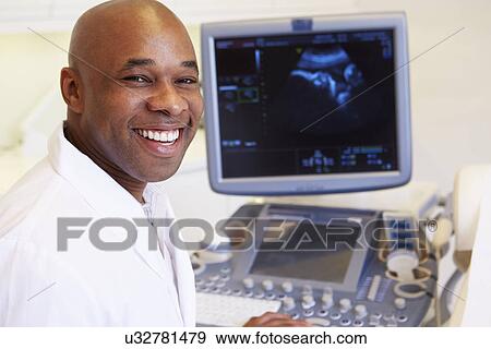 Stock Photo - Pregnant Woman And Partner Having 4D Ultrasound Scan. Fotosearch