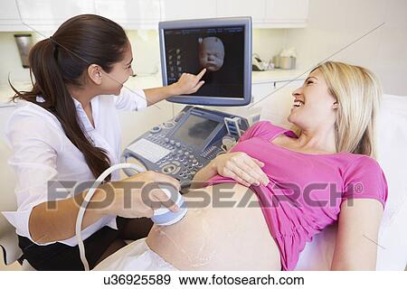 Pregnant Woman And Partner Having 4D Ultrasound Scan View Large Photo Image Stock Photo - Pregnant Woman And Partner Having 4D Ultrasound Scan. Fotosearch