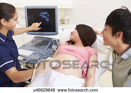 Pregnant Woman And Partner Having 4D Ultrasound Scan View Large Photo Image Stock Photo - Pregnant Woman And Partner Having 4D Ultrasound Scan. Fotosearch