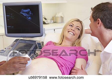 Stock Photo - Pregnant Woman And Partner Having 4D Ultrasound Scan. Fotosearch