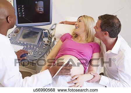 Stock Photo - Pregnant Woman And Partner Having 4D Ultrasound Scan. Fotosearch