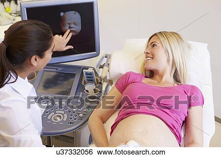 Pregnant Woman And Partner Having 4D Ultrasound Scan View Large Photo Image Stock Photograph - Pregnant Woman And Partner Having 4D Ultrasound Scan. Fotosearch
