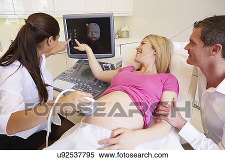 Stock Photography - Pregnant Woman And Partner Having 4D Ultrasound Scan. Fotosearch
