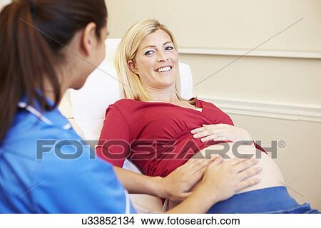 Picture - Pregnant Woman Being Given Ante Natal Check By Nurse. Fotosearch