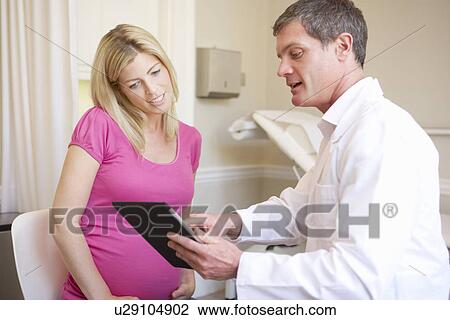 Stock Image - Pregnant Woman Being Given Ante Natal Check By Doctor. Fotosearch