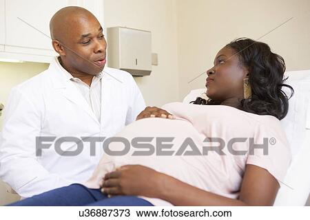 Stock Image - Pregnant Woman Being Given Ante Natal Check By Doctor. Fotosearch