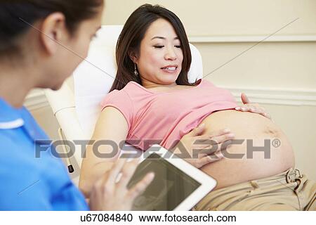 Pregnant Woman Being Given Ante Natal Check By Doctor View Large Photo Image Stock Image - Pregnant Woman Being Given Ante Natal Check By Doctor. Fotosearch