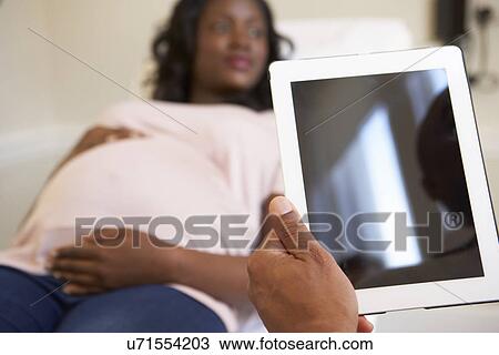 Pregnant Woman Being Given Ante Natal Check By Doctor View Large Photo Image Stock Image - Pregnant Woman Being Given Ante Natal Check By Doctor. Fotosearch