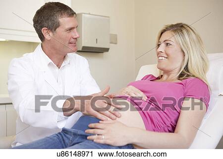 Stock Image - Pregnant Woman Being Given Ante Natal Check By Doctor. Fotosearch
