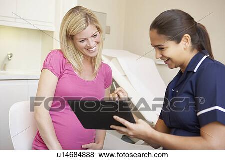 Pregnant Woman Being Given Ante Natal Check By Nurse View Large Photo Image Stock Photo - Pregnant Woman Being Given Ante Natal Check By Nurse. Fotosearch