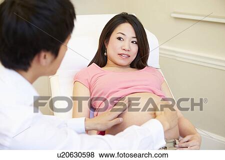 Pregnant Woman Being Given Ante Natal Check By Doctor View Large Photo Image Stock Photo - Pregnant Woman Being Given Ante Natal Check By Doctor. Fotosearch
