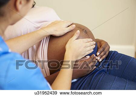 Stock Photo - Pregnant Woman Being Given Ante Natal Check By Nurse. Fotosearch